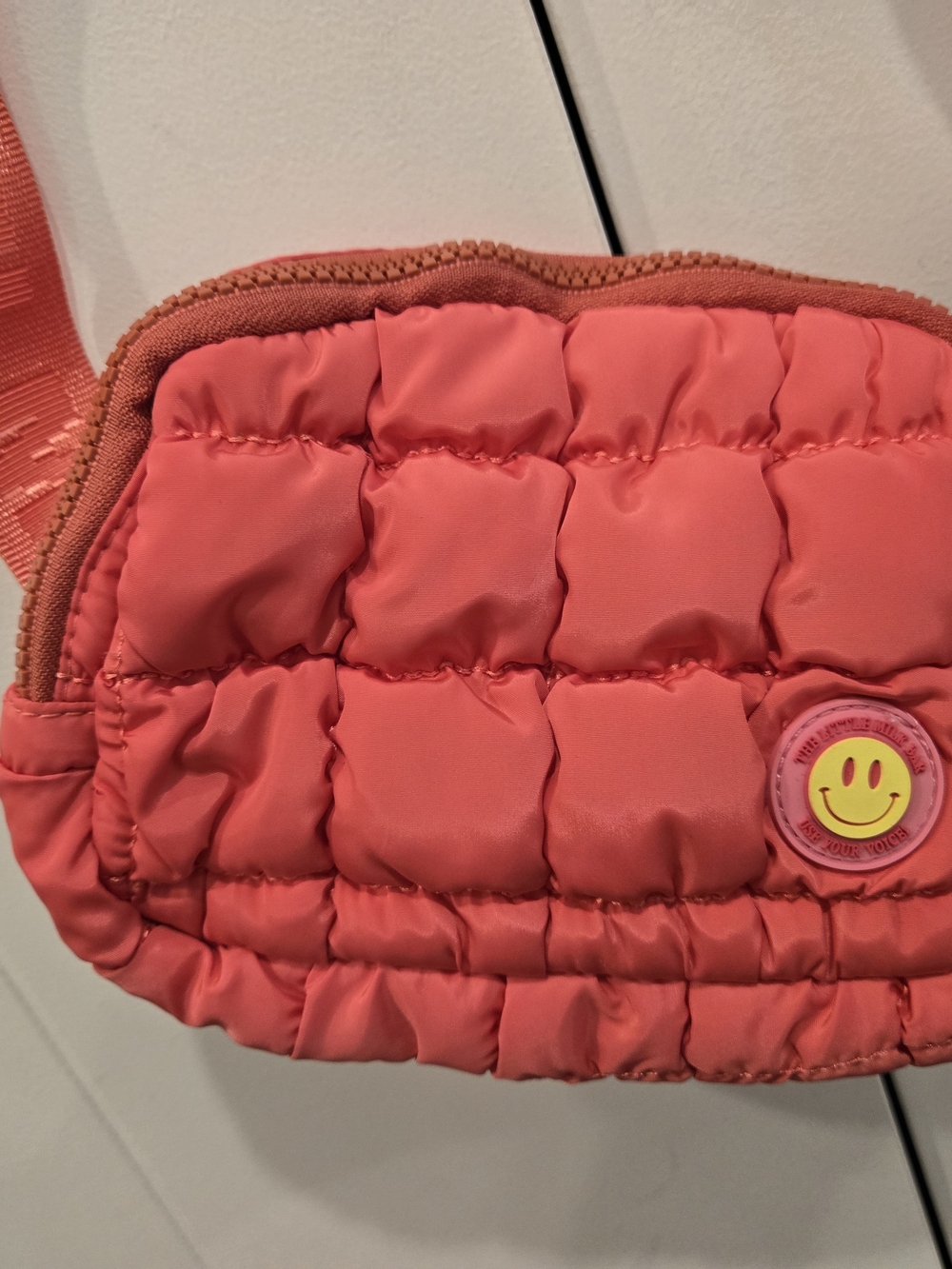 THE LITTLE MILK BAR Quilted Coral Crossbody Bag with Smiley Accent